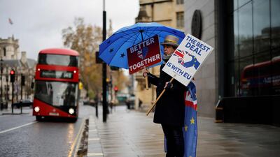 Anti-Brexit activist Steve Bray holds placards and an EU-themed umbrella as he stands outside a conference centre in central London on December 4. AFP