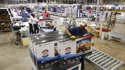 Workers stack boxes of television sets after they have been assembled, checked and repackaged, before moving them to the warehouse at Element Electronics in Winnsboro, South Carolina. Chris Keane / Reuters