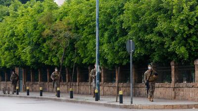 Lebanese army soldiers, wearing protective face masks, patrol a street in the capital Beirut. AFP