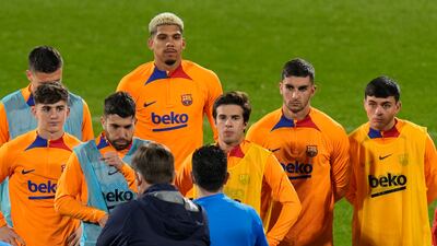 Barcelona players listen to instructions from head coach Xavi. AP Photo
