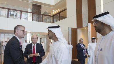 Sheikh Mohammed bin Zayed, Crown Prince of Abu Dhabi and Deputy Supreme Commander of the Armed Forces, centre, greets Mark Garrett, chief executive of Borealis, during roundtable discussions held by Adnoc ahead of Adipec. At right is Sultan Al Jaber, the Minister of State and chief executive of Adnoc. Mohammed Al Hammadi / Crown Prince Court – Abu Dhabi