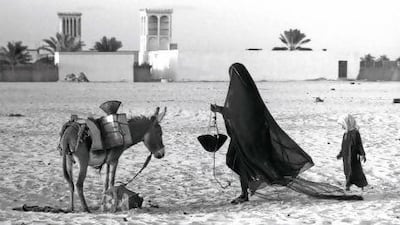 A woman collects water outside the fort. Ronald Codrai © TCA Abu Dhabi