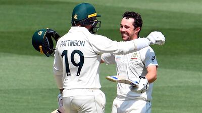 Australian batsman Travis Head celebrates with teammate James Pattinson after scoring his century against New Zealand on the second day of the second Test match in Melbourne on Friday. AFP