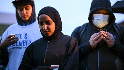 Ms Omar bows her head in a moment's silence at George Floyd Square in Minneapolis, where he died at the hands of Minneapolis police officers. Star Tribune / AP