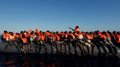 Migrants on a rubber dinghy await rescue by the Malta-based NGO Migrant Offshore Aid Station in the central Mediterranean in international waters about 15 nautical miles off the coast of Zawiya in Libya. Darrin Zammit Lupi / Reuters