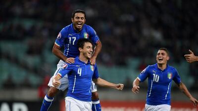Matteo Darmian, No 4, celebrates with his Italy teammates after scoring against Azerbaijan in Baku. Claudio Villa / Getty Images