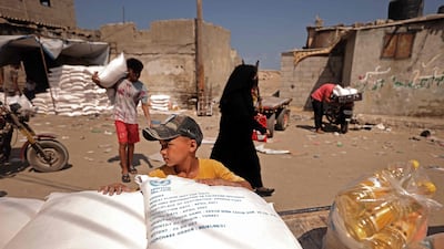 Palestinians collect food aid at a distribution centre run by United Nations Relief and Works Agency in Gaza city. AFP