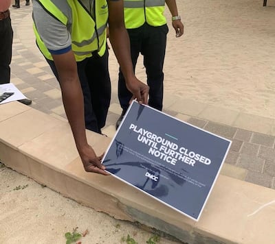 DMCC staff put up notices informing residents that playgrounds in Dubai's JLT area will be closed temporarily due to Covid-19. Courtesy: Vip Patel