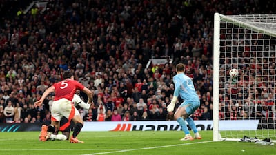 Harry Maguire scores Manchester United's fifth goal past Lyon goalkeeper Lucas Perri in extra time. Getty Images