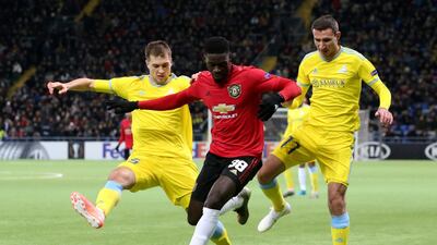 Manchester United's Axel Tuanzebe vies for the ball with Astana's Roman Murtazayev and Dmitri Shomko. Reuters