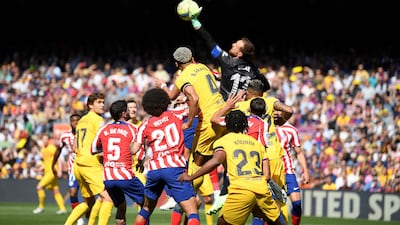 Atletico Madrid goalkeeper Jan Oblak punches the ball. AFP