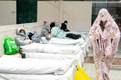 This photo taken on February 5, 2020 shows a patient covered in bed sheets at an exhibition centre converted into a hospital in Wuhan in China's central Hubei province. AFP