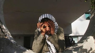 Bottom, a Palestinian man holds his head in his hands after Israeli forces launched an offensive in Gaza.