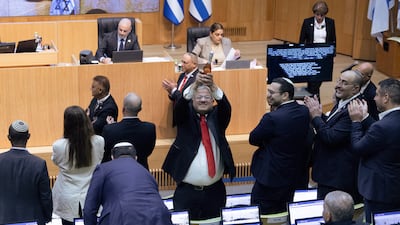 Israel's far-right National Security Minister Itamar Ben-Gvir celebrates in the Knesset after the bill is passed. Reuters