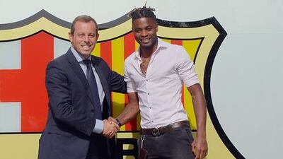 Alex Song shakes hands with Barcelona president Sandro Rosell at the Nou Camp following his transfer from Arsenal.
