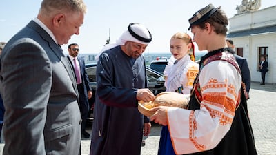 Sheikh Mohamed is presented with traditional bread and salt as he is welcomed by Mr Fico
