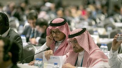 Delegates from Saudi Arabia pore over notes during the the opening session of the International Renewable Energy Agency assembly. Silvia Razgova / The National