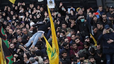 A man is carried away after he fainted during the funeral of five Hezbollah fighters who were killed in Syria's northwestern Idlib region, in the southern suburb of Beirut, Lebanon. AP Photo
