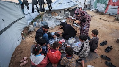 A displaced Palestinian family break their Ramadan fast during iftar at the Nuseirat refugee camp in the central Gaza Strip on February 26. AFP
