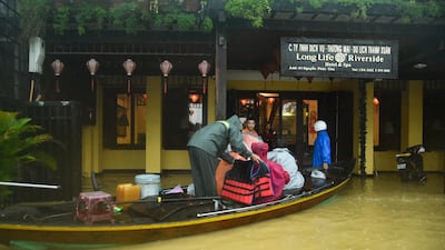 Tourists are evacuated from a hotel after a deluge of heavy rain sparked flooding, in Hoi An, Vietnam. AFP