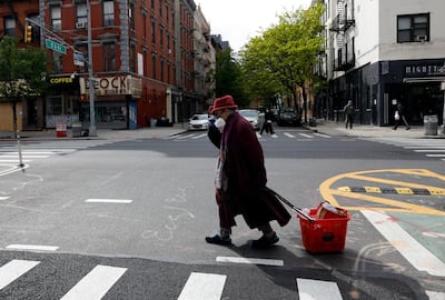 An elderly woman crossing the street on the Lower East Side of New York, 9 May. Jason Szenes / EPA