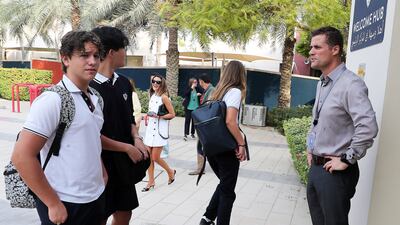 David Hutson, right, head teacher at Dwight School in Dubai, greets returning pupils. Pawan Singh / The National