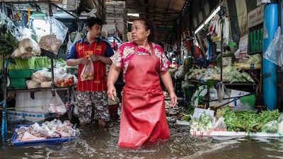 A metre of floodwater closes in on vendors selling vegetables in the Bang Kapi district of the Thai capital. AFP