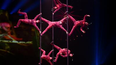 The first act is a group of Chinese pole dancers dressed as red ants