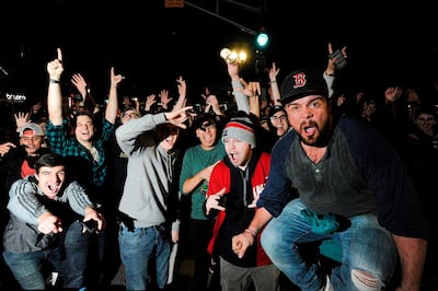 Fans celebrate the Red Sox World Series victory over the Los Angeles Dodgers at Kenmore Square in Boston. AFP