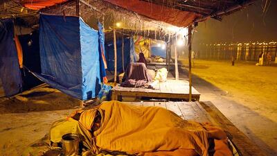 A Hindu devotee sleeps at Sangam, the confluence of the rivers Ganges, Yamuna and the Saraswati during the traditional fair of Magh Mela, in Allahabad. Rajesh Kumar Singh / AP Photo