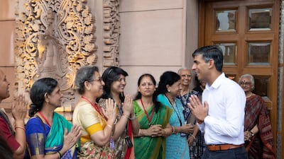 Women greet British Prime Minister Rishi Sunak during his visit to the Swaminarayan Akshardham Hindu temple. Reuters