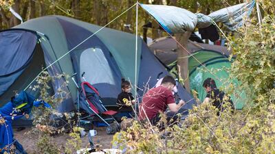A family eat dinner at their living site just prior to its eviction in Grande-Synthe, 22 October 2018. Courtesy Adrian Abbott