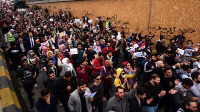 Iraqi university students carry placards during a strike and protests in central Baghdad. EPA