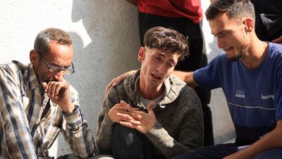 Palestinians mourn relatives killed near an aid distribution centre in central Gaza, at Al Shifa Hospital, Gaza City, on Wednesday. Reuters