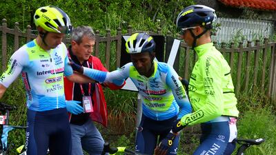 Team Intermarche's Eritrean rider Biniam Girmay, centre, is helped by teammates after his crash. AFP