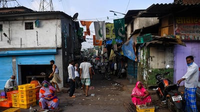 Residents purchase milk along a road leading to the Dharavi slum. AFP