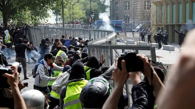 Protesters push on a fence surrounding a police station on the Boulevard de L'Hopital, near the Place d'Italie, on the sidelines of the annual May Day rally in Paris. AFP