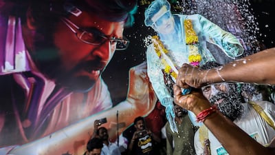 A person sprays milk as they celebrate the release of the movie. EPA