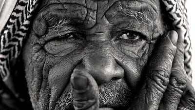 Nasser Haji Malek originally photographed the man touching his face in colour, but felt it worked better in black and white.