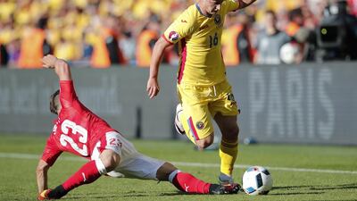 Romania's Steliano Filip is tackled by Switzerland's Xherdan Shaqiri during the Euro 2016 Group A soccer match between Romania and Switzerland at the Parc des Princes stadium in Paris, France, Wednesday, June 15, 2016. (AP Photo/Christophe Ena)