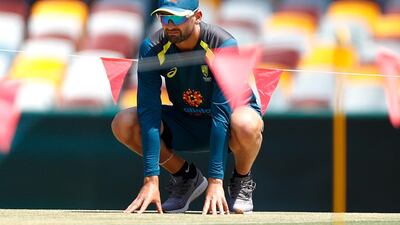 Australia spinner Nathan Lyon inspects the pitch at the Gabba. Getty