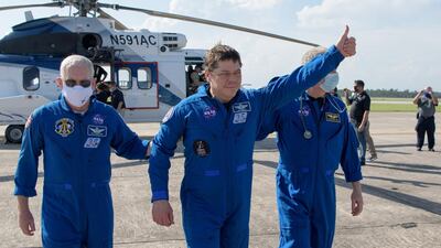 NASA astronaut Robert Behnken gives a thumbs up to onlookers as he boards a plane at Naval Air Station Pensacola. REUTERS-