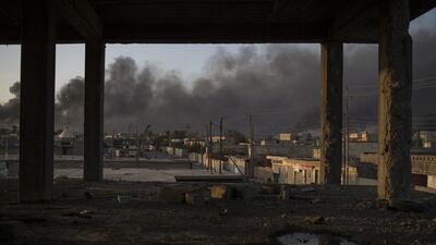 Smoke rises from burning oil fields in Qayara, 50 kilometres south of Mosul. Felipe Dana / AP Photo
