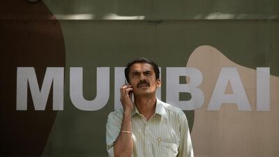 A man speaks on his phone outside the Bombay Stock Exchange (BSE) building in Mumbai. The Independent will revert to using Bombay rather than Mumbai in it's publication. Punit Paranjpe / AFP Photo