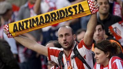 A supporter of Atletico Madrid shows his support before the Champions League match against Real Madrid on Tuesday night at the Vicente Calderon. Dani Pozo / AFP