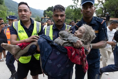 After spending eight hours stuck in mud, Ms Bohra is taken to hospital in Kathmandu for treatment. EPA
