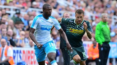 Chancel Mbemba of Newcastle takes on Fabian Johnson of Borussia Moenchengladbach. Mark Runnacles / Getty Images