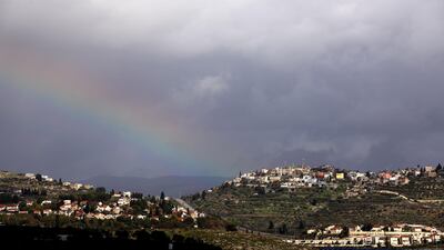 A rainbow is seen during rainy and cold weather over the Palestinian village of Jet (R) and Jewish settlement of Qadomim near the West Bank city of Nablus. EPA