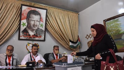 A Syrian woman casts her ballot at a polling station in the Nubl neighbourhood of Aleppo on July 19. AFP