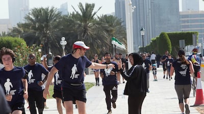 Participants running at the Terry Fox Run, Corniche Beach.